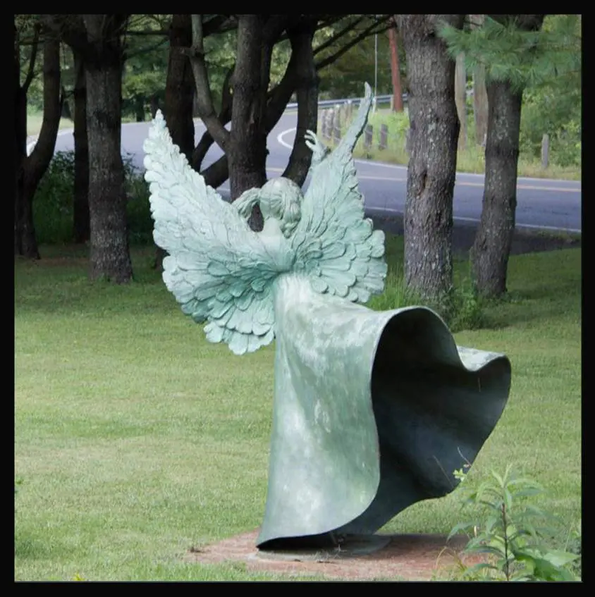 A statue of an angel with wings spread.