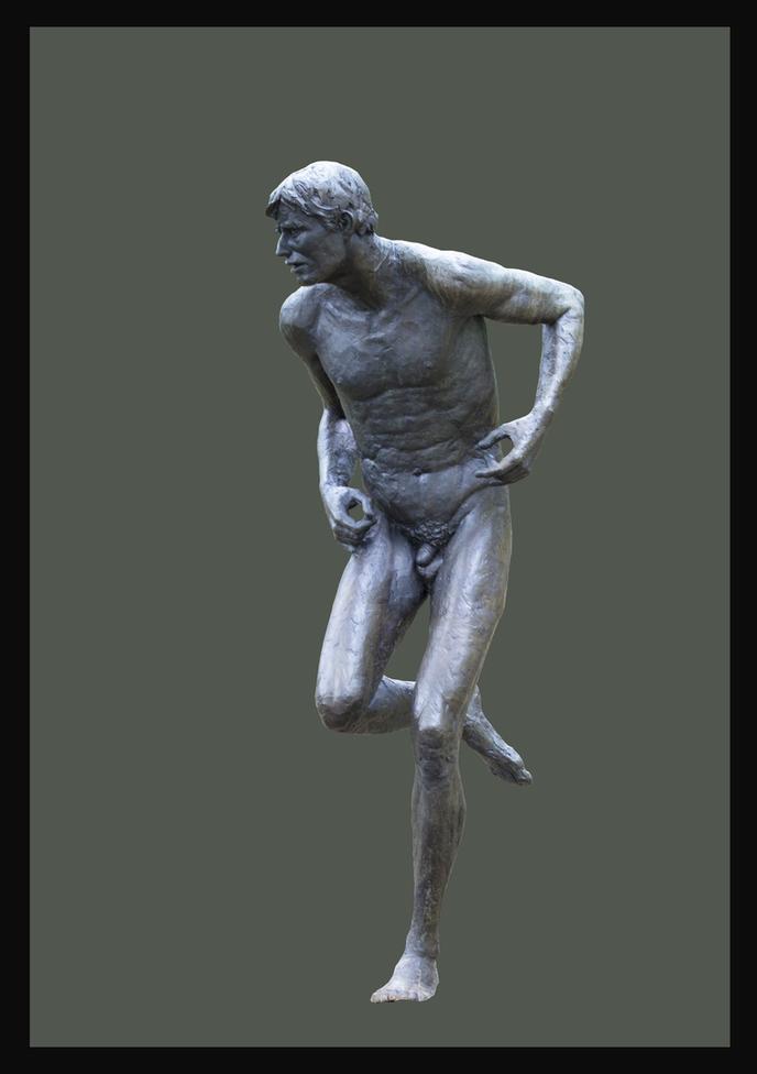 A statue of a man running in the street.