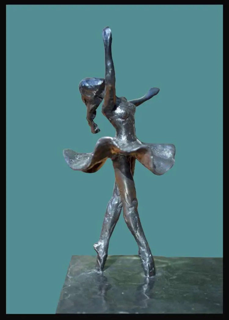 A metal sculpture of a woman in a pose.