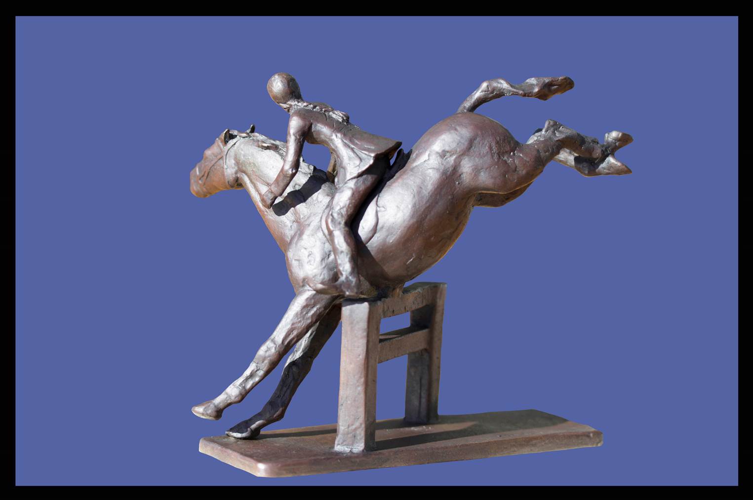 A bronze statue of a jockey on horseback.