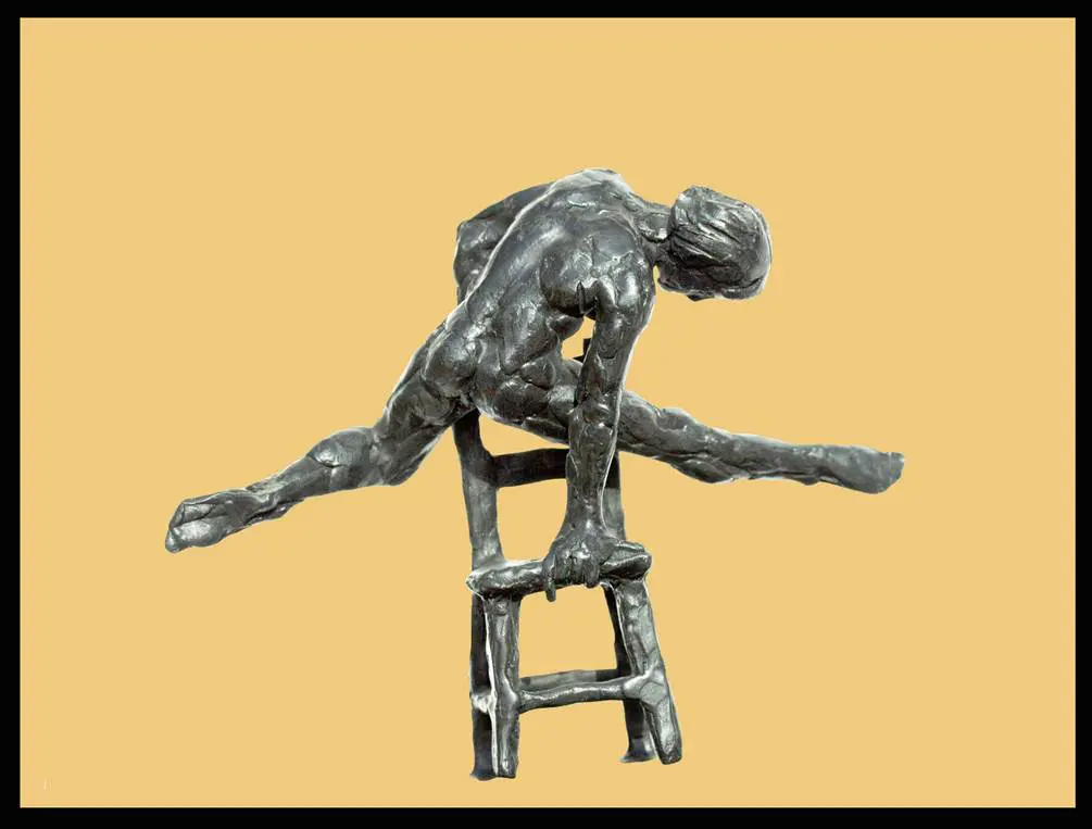 A sculpture of a man sitting on top of a stool.