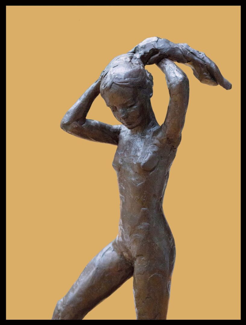 A bronze statue of a woman holding her head.